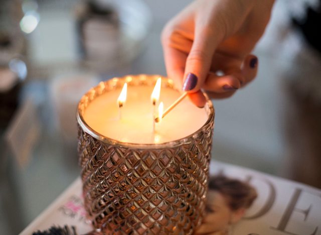 close-up woman lighting candle