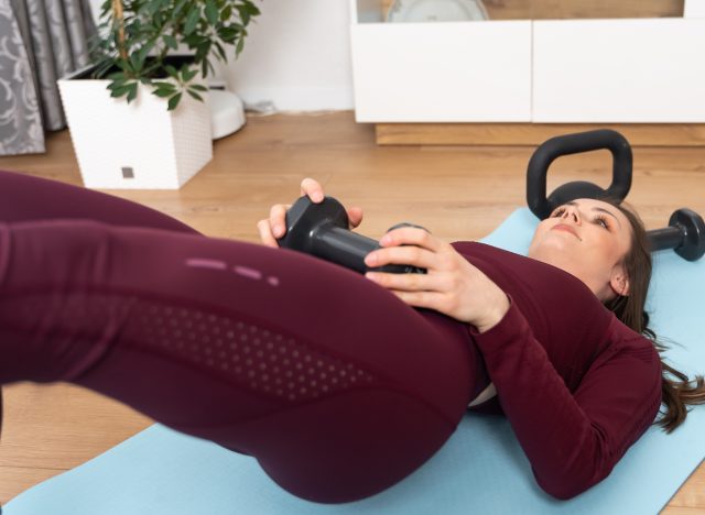 woman doing weighted glute bridge