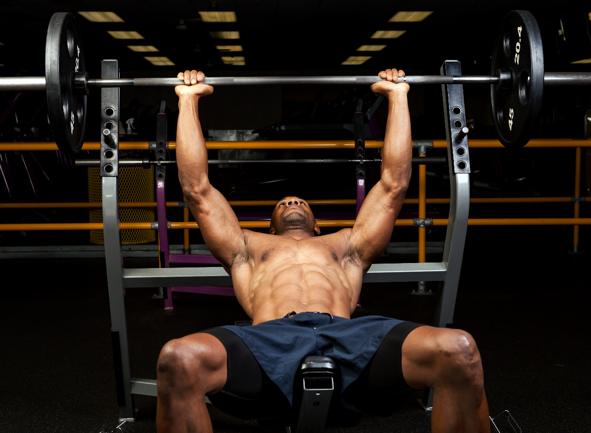 fit man doing barbell bench press, concept of strength exercises for men