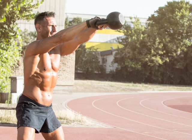 fit man doing kettlebell swings, concept of daily strength exercises for men to lose weight