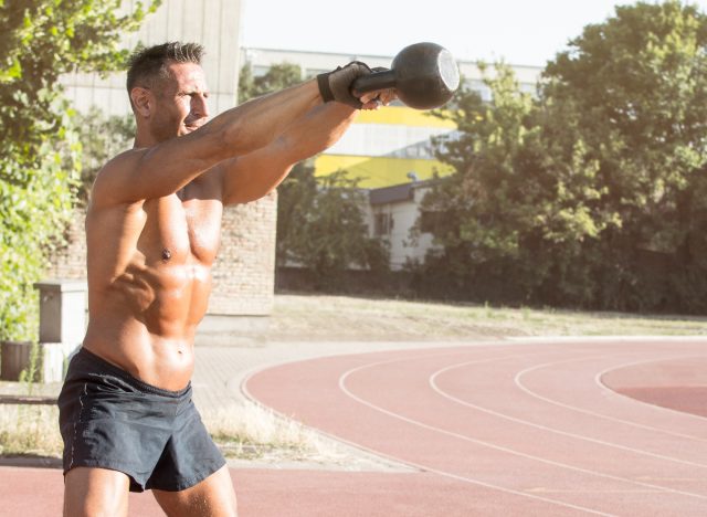 fit man doing kettlebell swings, concept of daily strength exercises for men to lose weight