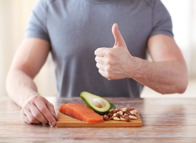 fit muscular man with tray of lean protein, concept of nutrition tips for men to build muscle