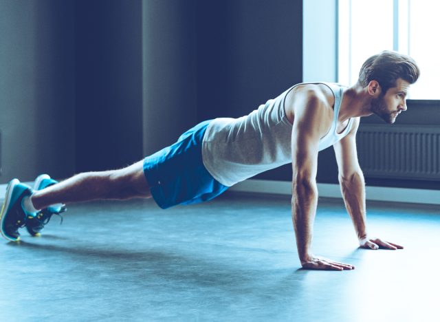 fit man doing pushups, concept of find out how fit you are with a trainer's test