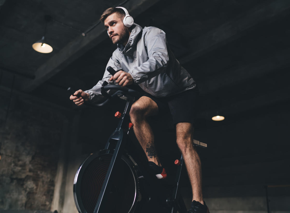 man indoor cycling, concept of daily exercises for men to lose weight