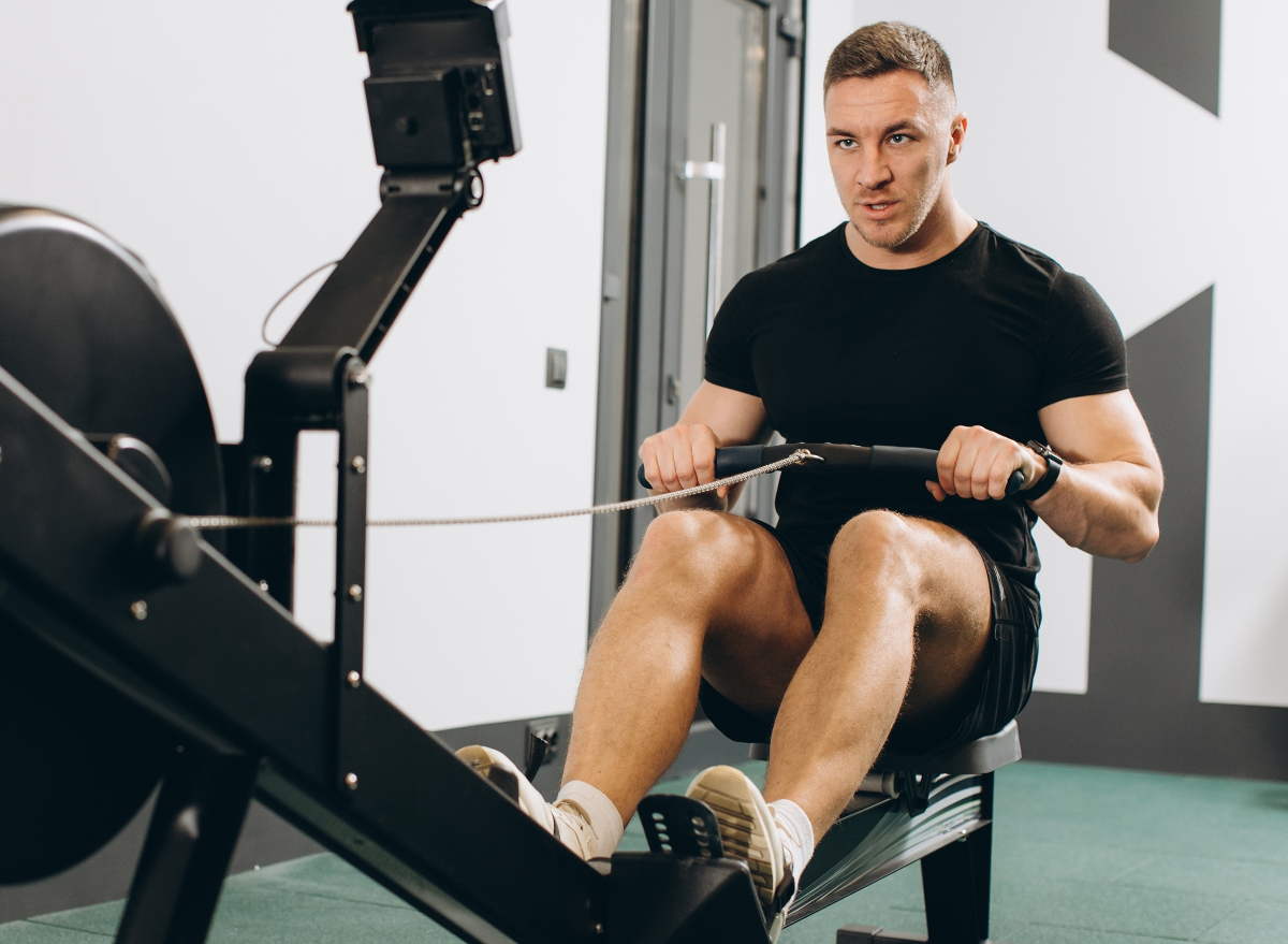 man using rowing machine, concept of cardio strength exercises for faster abdominal fat loss