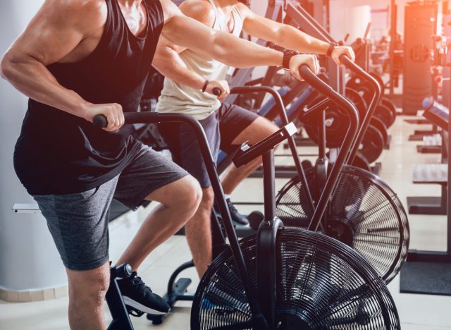 close-up men on air bikes