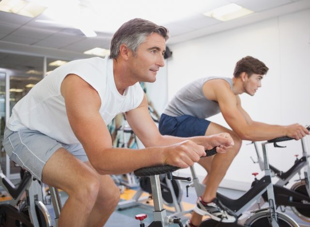 middle-aged man doing indoor cycling