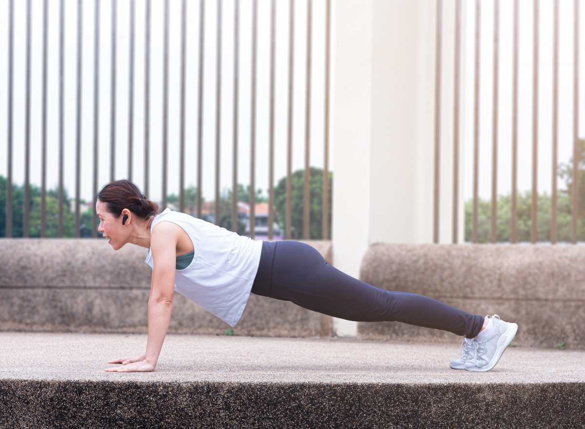 middle-aged woman doing pushups, concept of floor exercises for quicker weight loss after 40