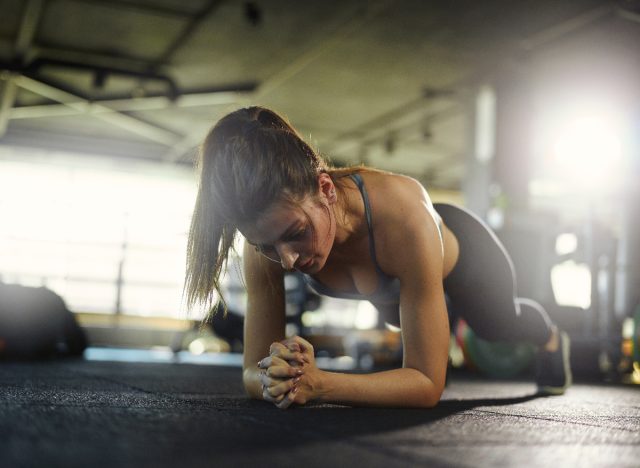 fit woman doing forearm planks