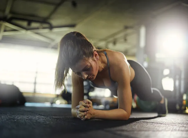 fit woman doing forearm planks