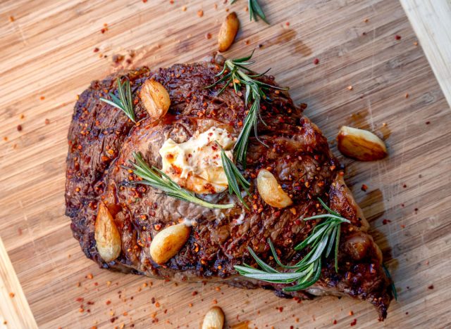 garlic cloves on cooked steak