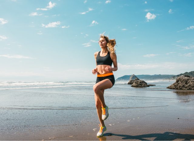 woman doing HIIT exercises on beach, concept of exercises to melt stomach fat