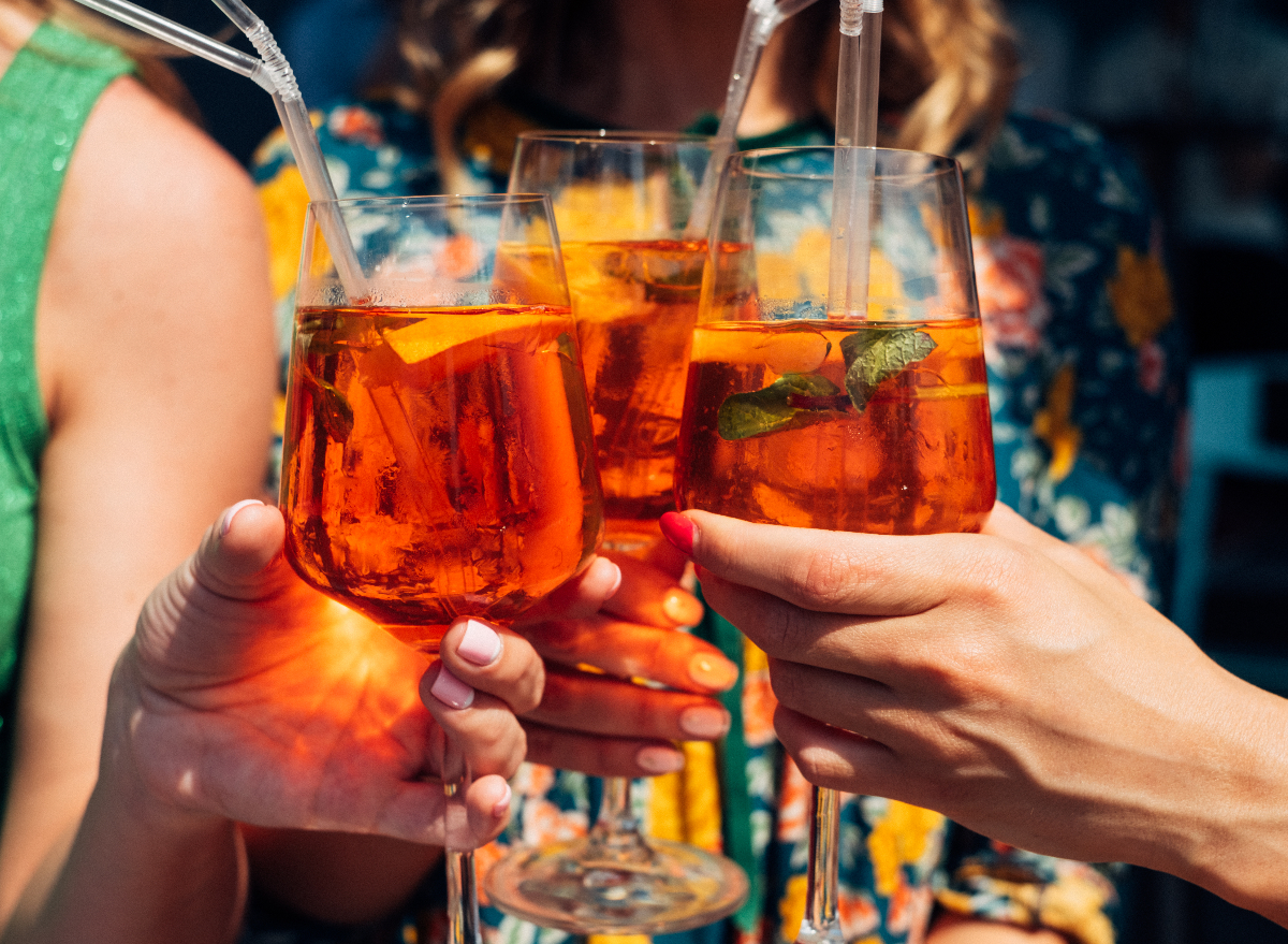 women toasting Aperol Spritz glasses, concept of how to lose weight without giving up alcohol