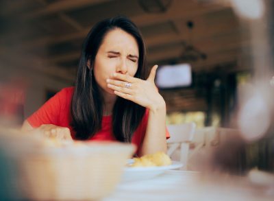 Woman grimacing at food