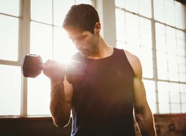 fit man lifting weights, how in shape you are in your 40s concept