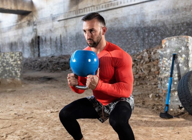 fit man doing kettlebell squats, concept of strength exercises to look and feel younger