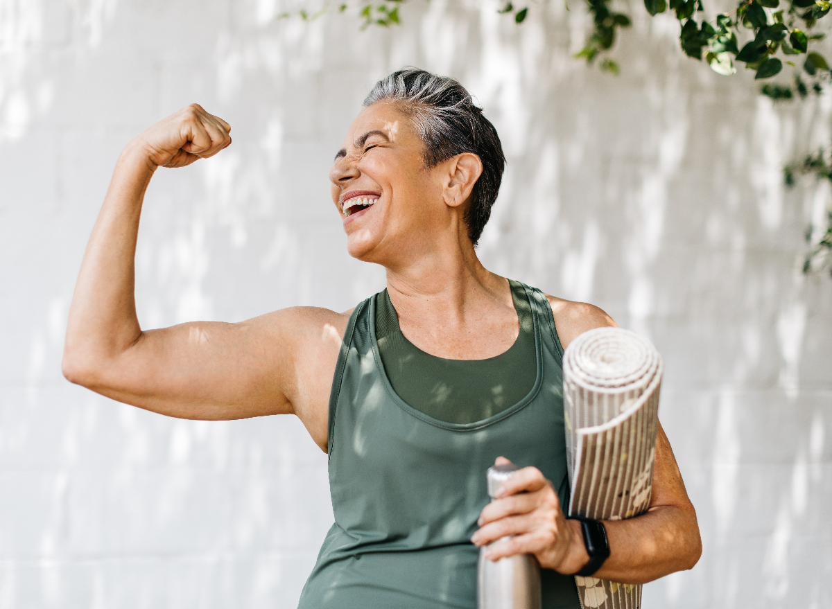 mature happy fitness woman flexing, concept of habits for women to offset aging