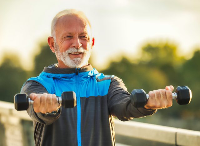 mature man doing dumbbell exercises, concept of strength workouts for men over 60