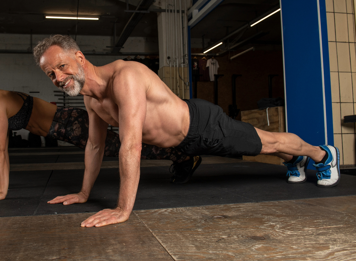 mature man doing pushups, concept of exercises for men to prevent muscle loss after 50