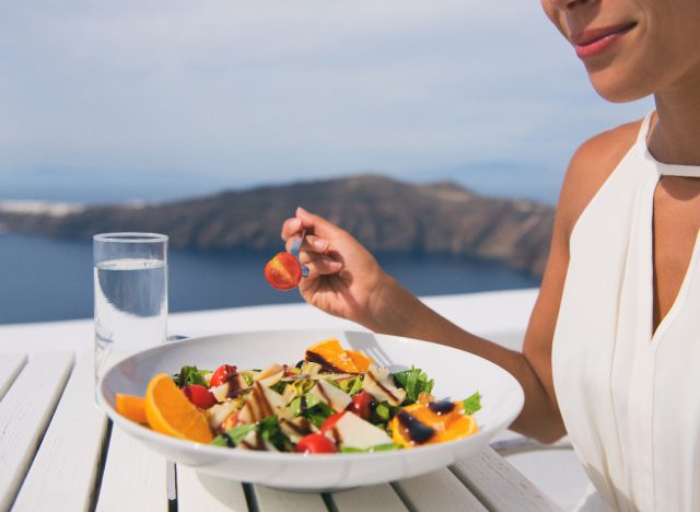 Mediterranean Diet concept, woman eating salad