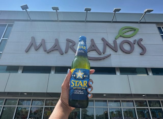 person holding beer in front of mariano's