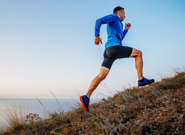man running uphill, concept of how to build endurance for longer runs