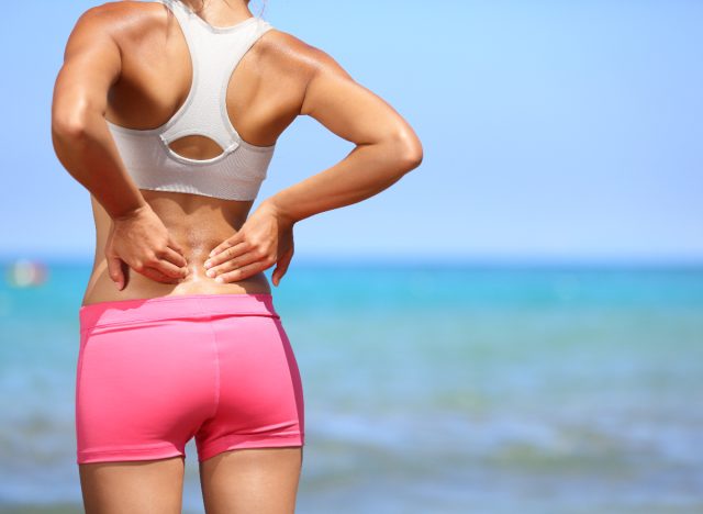 close-up woman dealing with back pain while exercising