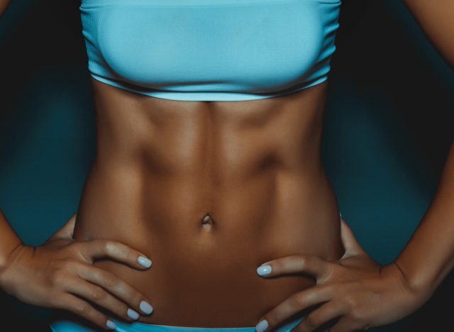 woman close-up abs, concept of standing workout for ripped abs