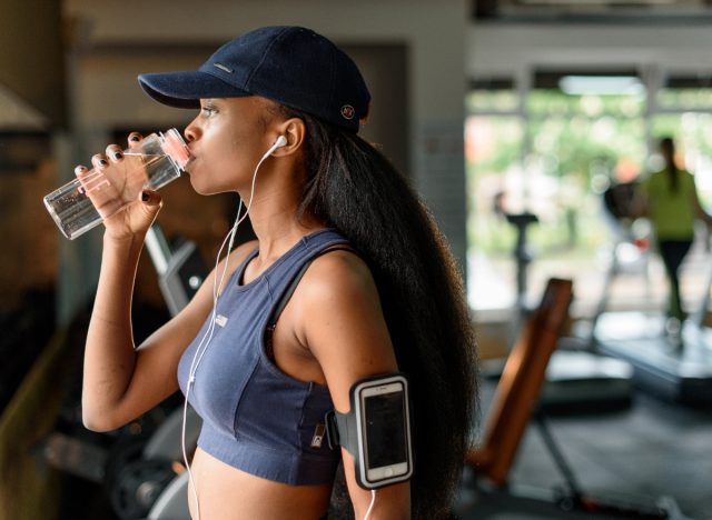 woman drinking water at the gym