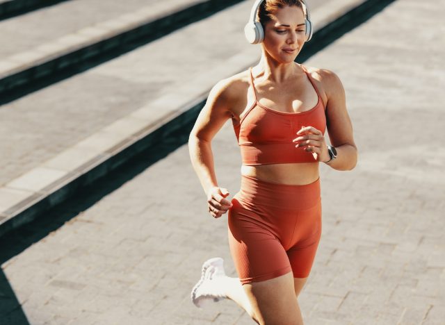 fit woman running outdoors, concept of best exercises to melt belly fat
