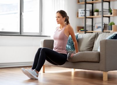 woman doing tricep dips, concept of at-home exercises for women to get rid of armpit pooch