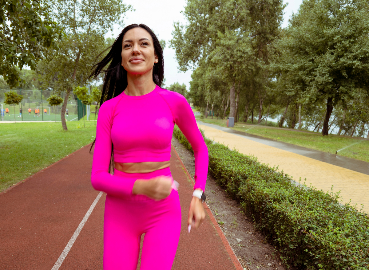 woman walking on track, concept of 50-mile month walking challenge