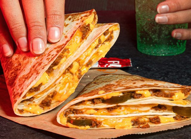hand holding a Taco Bell Stacker