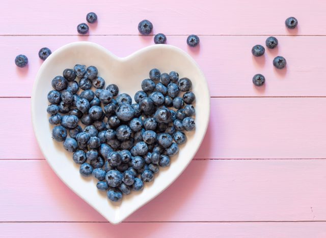heart-healthy foods concept, blueberries in heart-shaped bowl