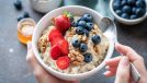 bowl of oatmeal with strawberries and blueberries and walnuts