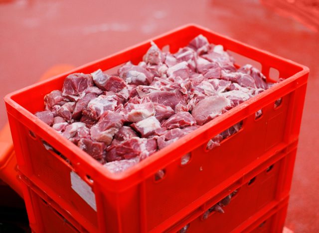 chopped raw meat in red crates