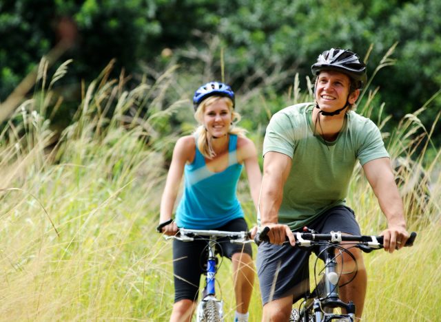 couple biking, concept of fitness tips to boost heart health