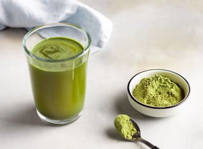 greens powder next to a glass