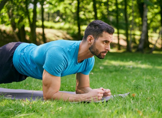 man doing planks, concept of strength workouts for men to lose weight