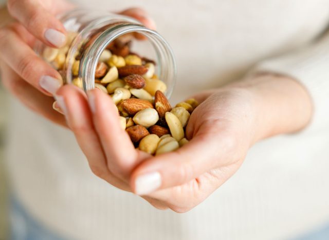 pouring nuts as snack out of glass jar