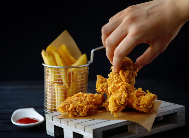 person holding fried chicken