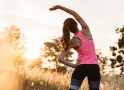 woman outdoors morning stretching, concept of morning habits for all-day energy