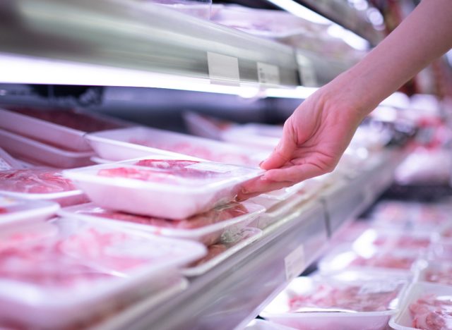 woman picking packaged meat