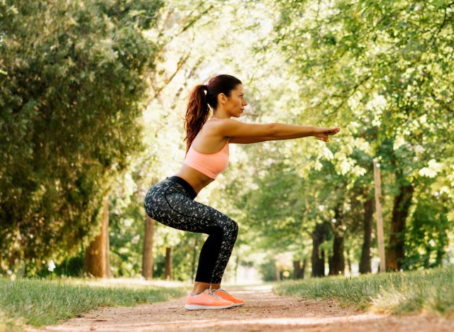 woman doing squats, concept of daily HIIT workout for women