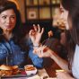 Two young women at a lunch in a restaurant