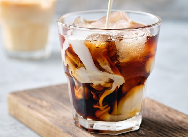 Pouring cream in iced coffee