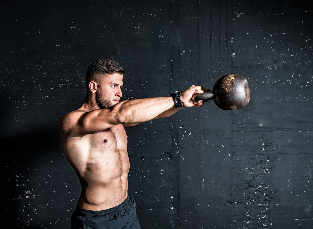 man doing kettlebell swings, concept of HIIT workouts for men