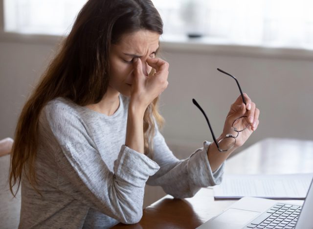 woman rubbing eyes, concept of things an eye doctor never does