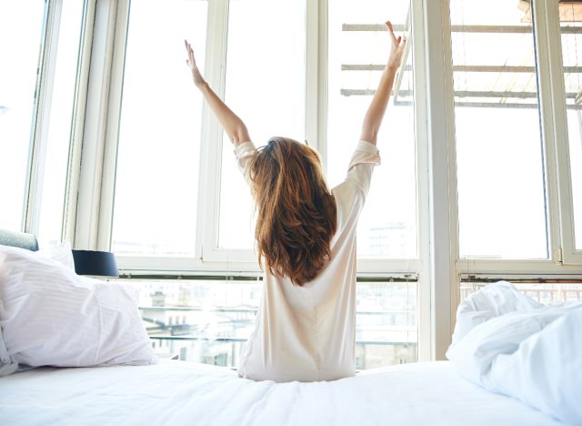 woman waking up, stretching