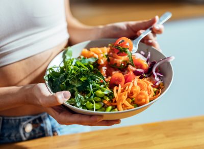 woman eating vegetables big healthy carb salad